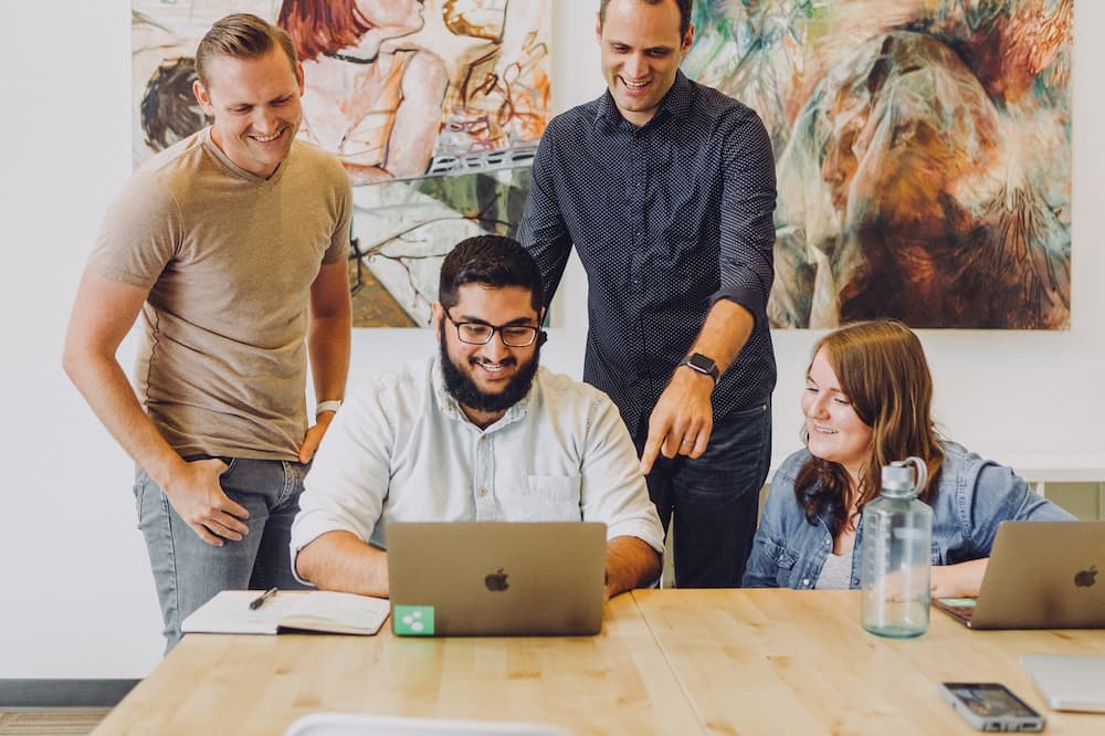 A group of employees gathered around each other to set goals for each other