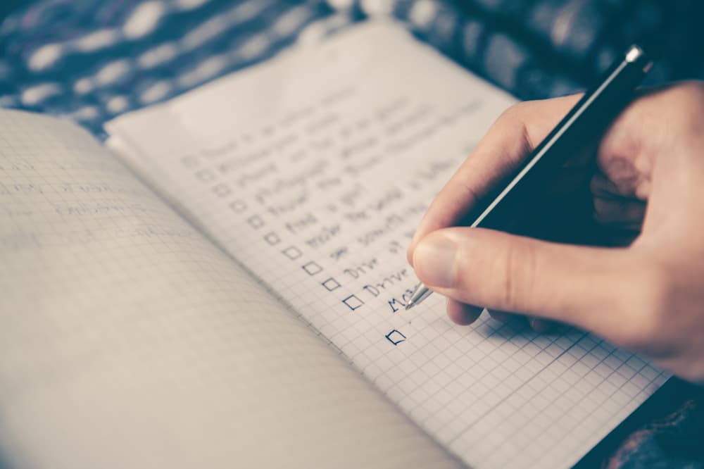 A person working on a list to tick off as a planner